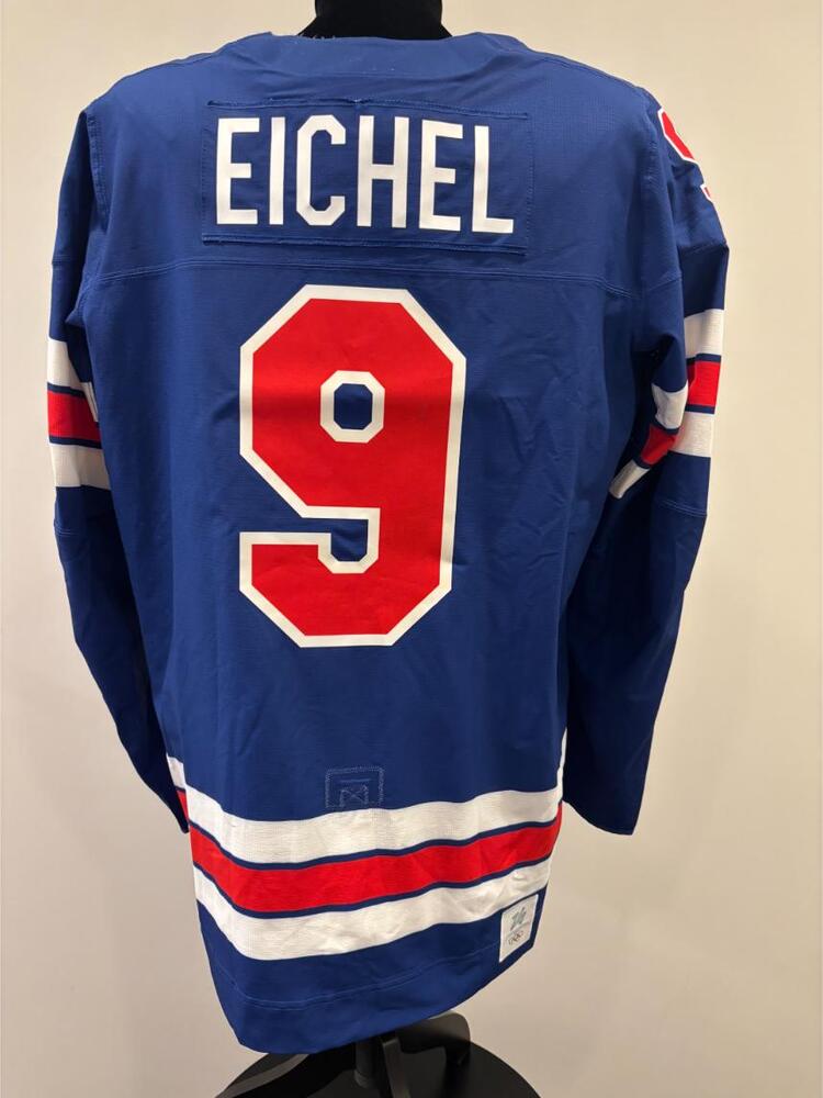 Jack Eichel USA Game-Used Blue Jersey worn v. Denmark on February 14, 2026, as a part of the 2026 Milano Cortina Winter Games.