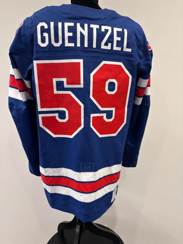 Jake Guentzel USA Game-Used Blue Jersey worn v. Denmark on February 14, 2026, as a part of the 2026 Milano Cortina Winter Games.