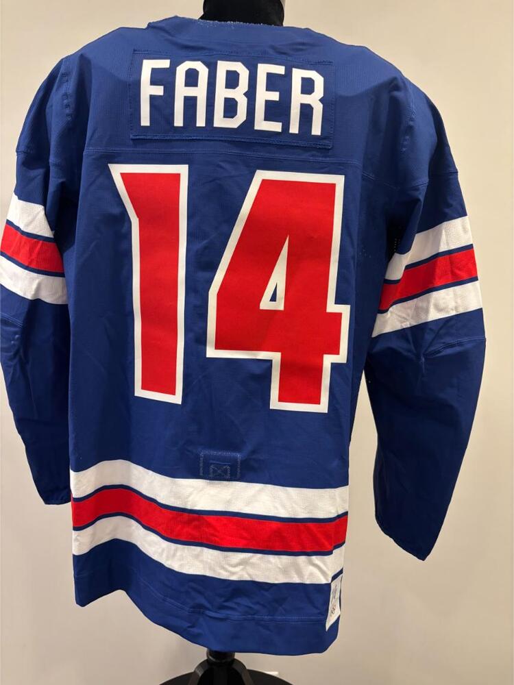 Brock Faber USA Game-Used Blue Jersey worn v. Denmark on February 14, 2026, as a part of the 2026 Milano Cortina Winter Games.