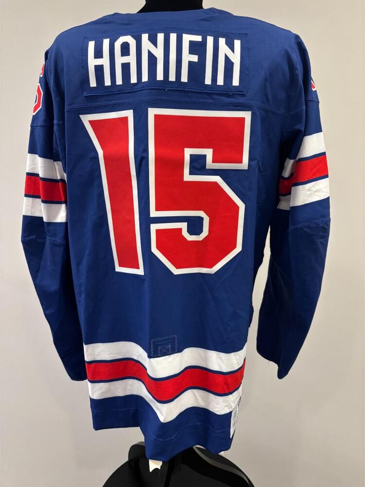 Noah Hanifin USA Game-Used Blue Jersey worn v. Denmark on February 14, 2026, as a part of the 2026 Milano Cortina Winter Games.