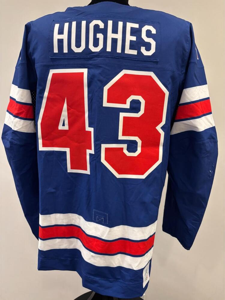 Quinn Hughes USA Game-Used Blue Jersey worn v. Denmark on February 14, 2026, as a part of the 2026 Milano Cortina Winter Games.