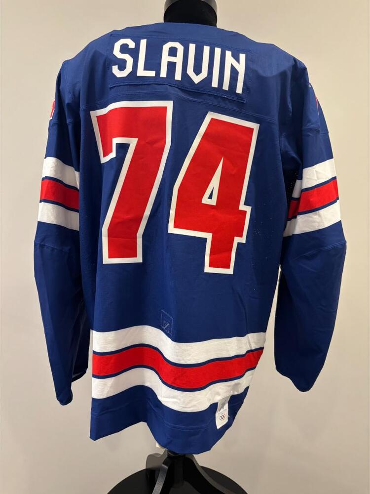 Jaccob Slavin USA Game-Used Blue Jersey worn v. Denmark on February 14, 2026, as a part of the 2026 Milano Cortina Winter Games.