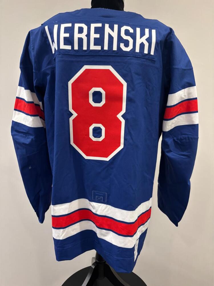 Zach Werenski USA Game-Used Blue Jersey worn v. Denmark on February 14, 2026, as a part of the 2026 Milano Cortina Winter Games.