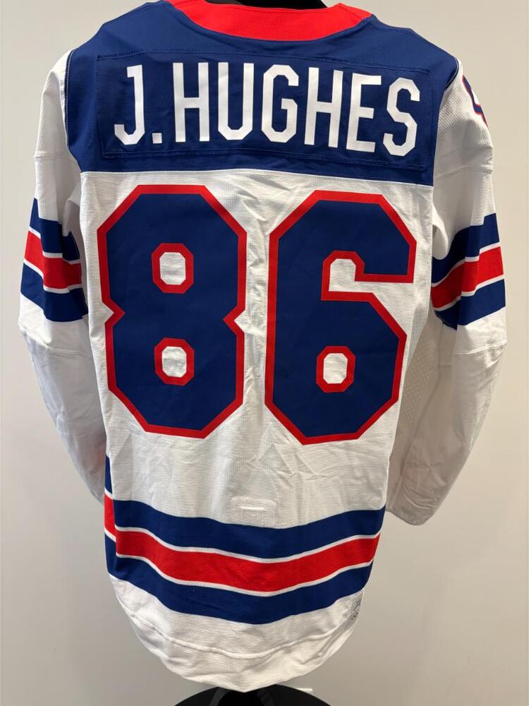 Jack Hughes USA Game-Used White Jersey worn v. Germany on February 15, 2026, as a part of the 2026 Milano Cortina Winter Games.