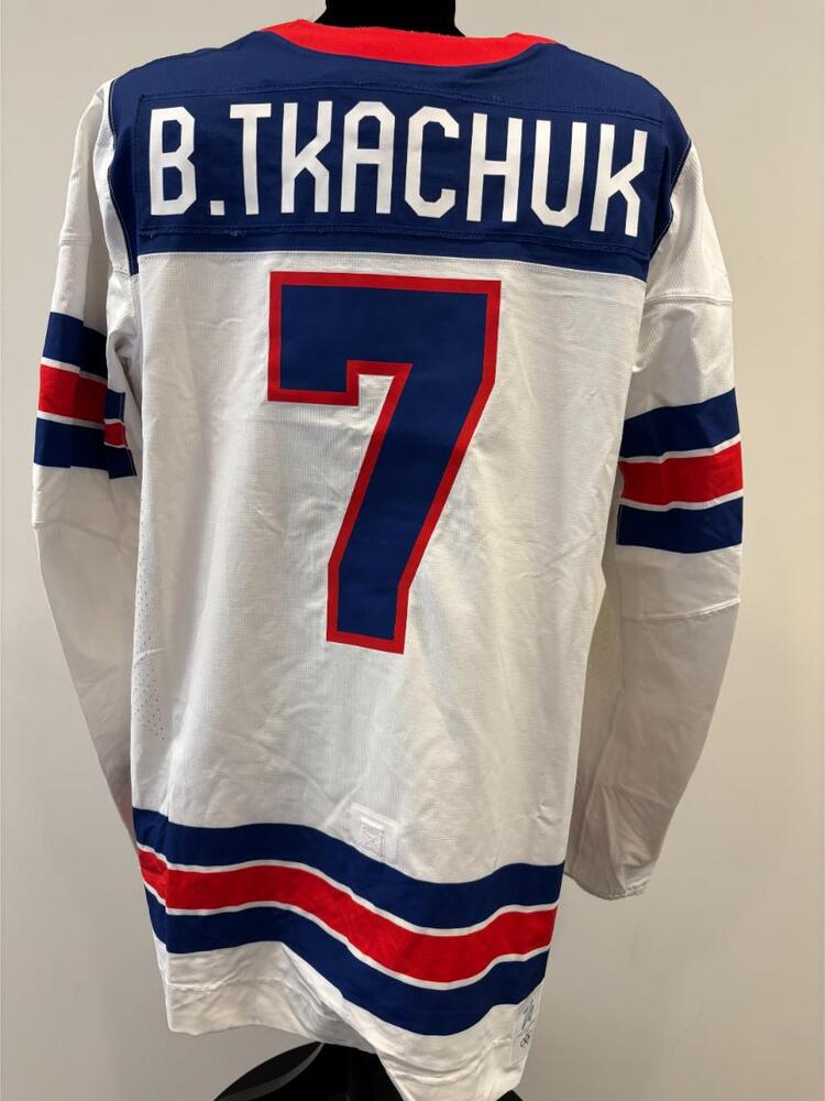 Brady Tkachuk USA Game-Used White Jersey worn v. Germany on February 15, 2026, as a part of the 2026 Milano Cortina Winter Games.