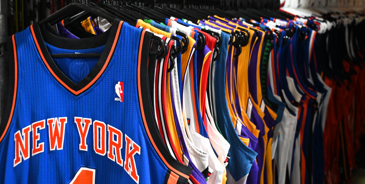 Rack of multiple team jerseys for sale in the MeiGray Warehouse.