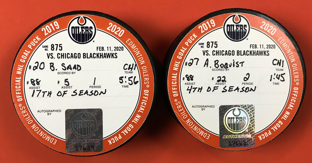 Brandon Saad 20 & Adam Boqvist 27 Chicago Blackhawks Goal Pucks