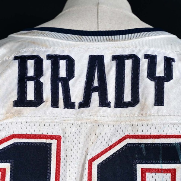 Close-Up of Tom Brady’s White New England Patriots Jersey displaying the ‘Brady’ nameplate.