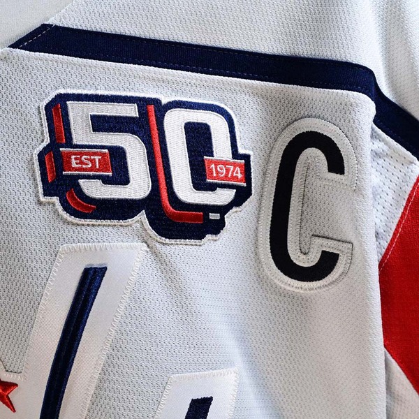 Close-Up of 50th Anniversary Patch and Captain’s ‘C’ on Front of Alex Ovechkin White Washington Capitals Game-Worn Photo-Matched Jersey.